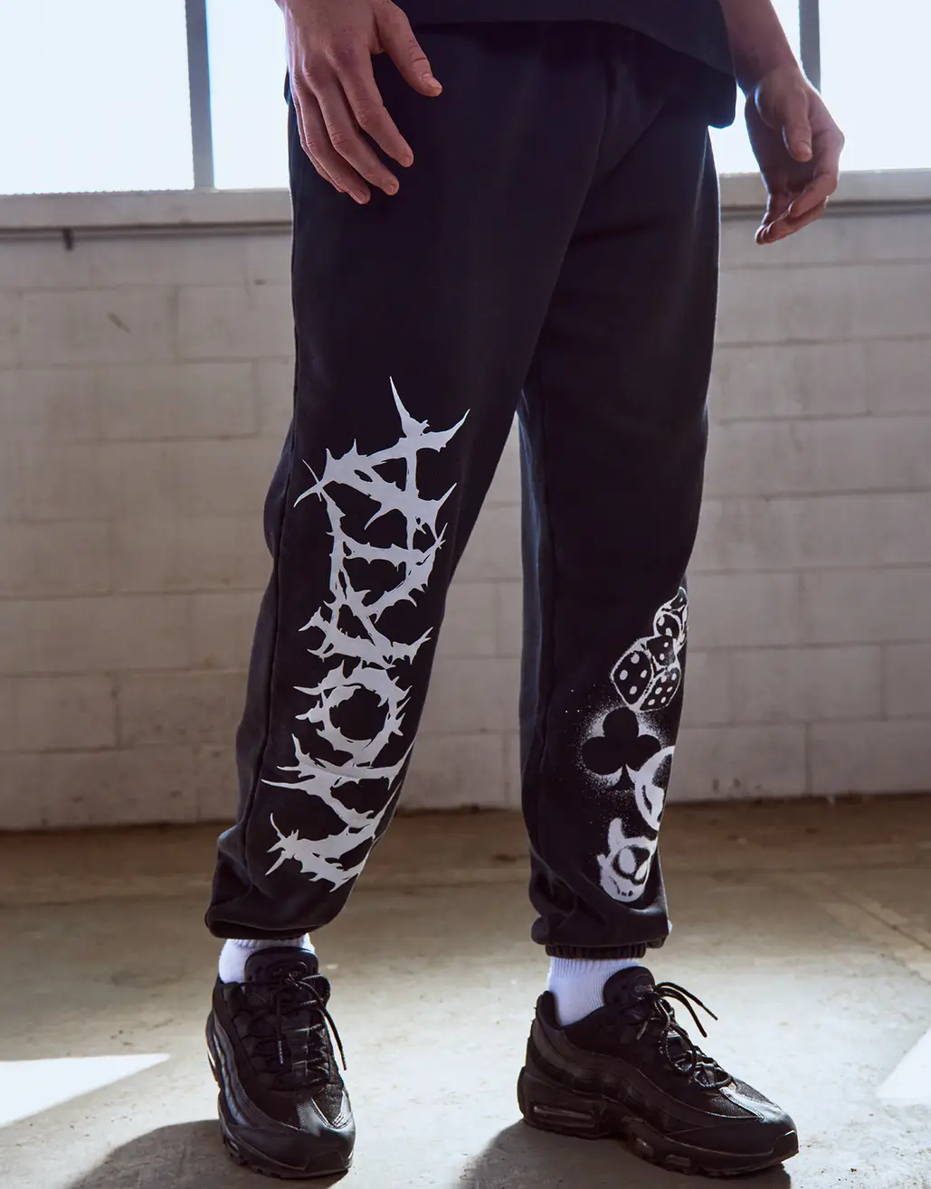 MORTA GRAFFITTI PRINT TRACK PANTS IN WASHED BLACK